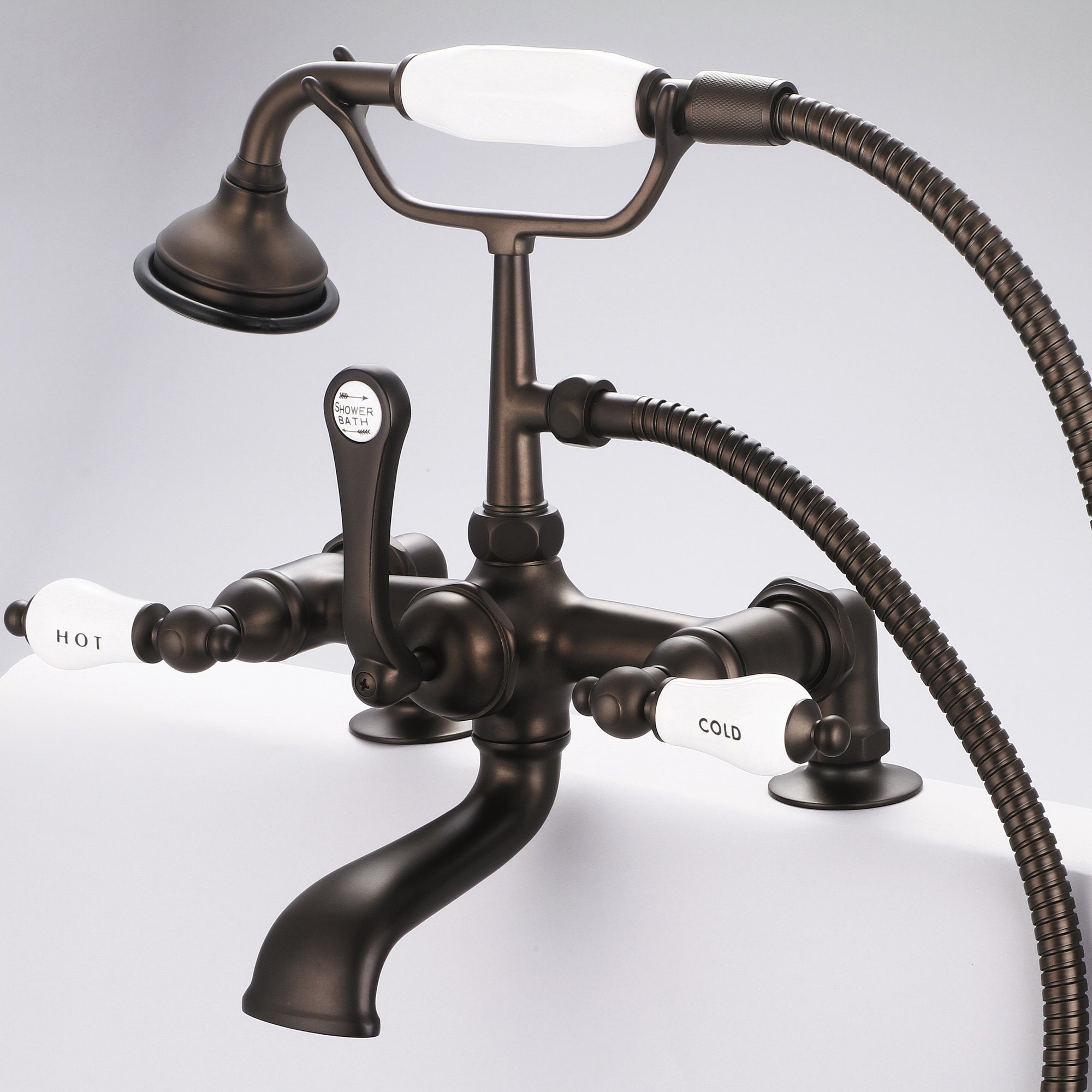 Water Creation | Vintage Classic 7 Inch Spread Deck Mount Tub Faucet With 2 Inch Risers & Handheld Shower in Oil-rubbed Bronze Finish Finish With Porcelain Lever Handles, Hot And Cold Labels Included | F6-0007-03-CL Water Creation | Vintage Classic 7 Inch Spread Deck Mount Tub Faucet With 2 Inch Risers & Handheld Shower in Oil-rubbed Bronze Finish Finish With Porcelain Lever Handles, Hot And Cold Labels Included | F6-0007-03-CL